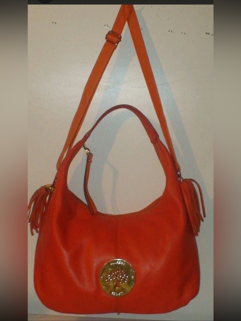 Mulberry Orange Leather Hobo Bag with Tassels and Gold Emblem
